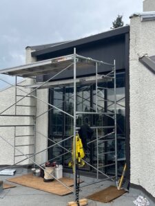 Metal cladding being worked on beneath the S.E. stained glass windows
