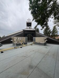 Completed N.E. roof, metal clad walls beside the stained glass windows and above windows